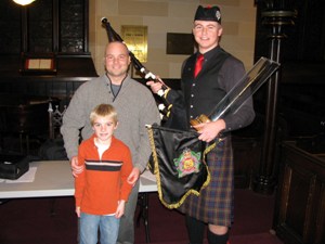 Jamie and Tyler Sherriff presenting trophy and banner to Richard Gillies