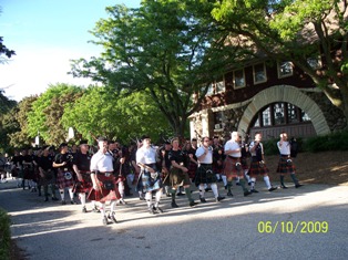 Massed pipes and drums marching through Delafield to the pub/ceilidh night